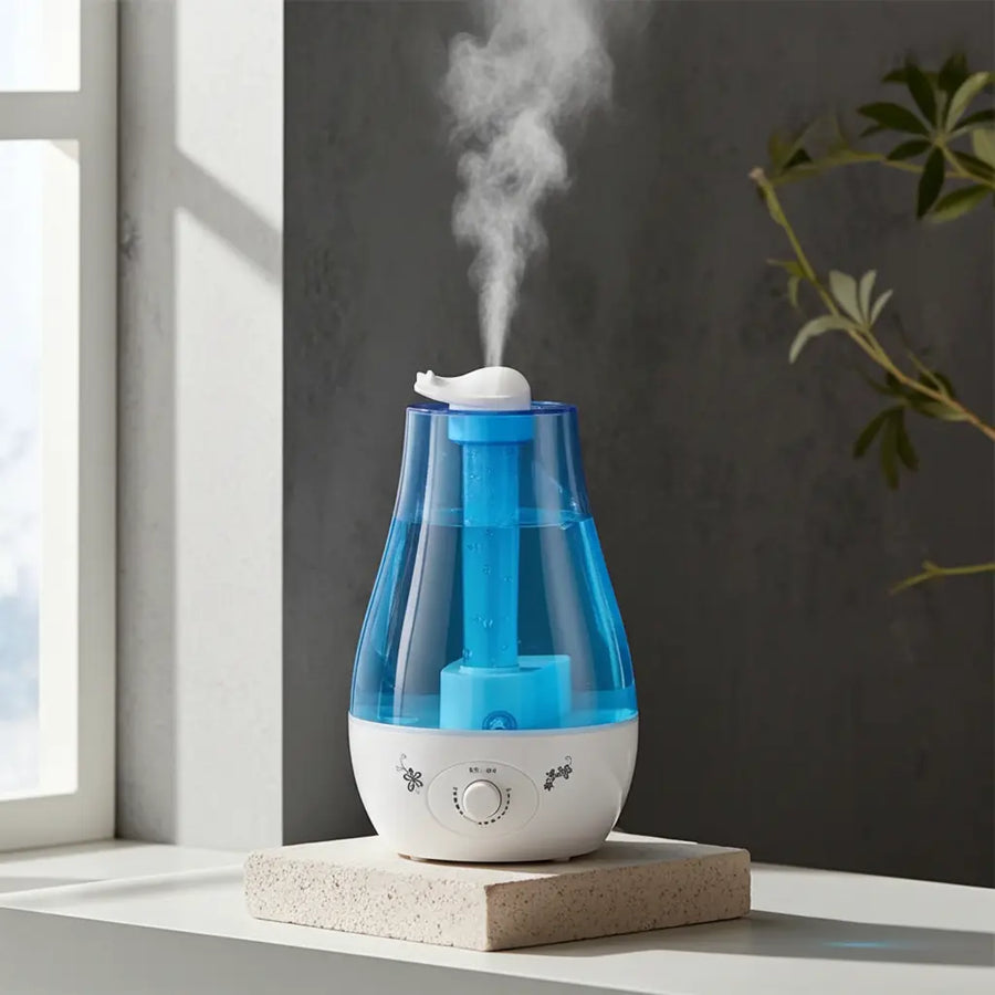 Blue QuietAura humidifier with soft amber LED glow on a wooden nightstand