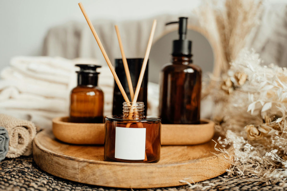A soothing aromatherapy arrangement with amber bottles and dried flowers, perfect for a calming atmosphere.