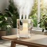 1.5L Triple Spray Humidifier with large mist volume, ambient night light, portable leather handle, and digital display on a wooden table in a bright modern living room