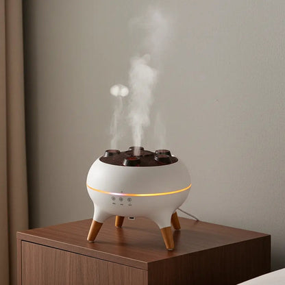 White diffuser with wooden legs emitting steam on a wooden surface against a plain wall.