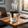 Humidifier on a desk with a laptop and notebook in the background