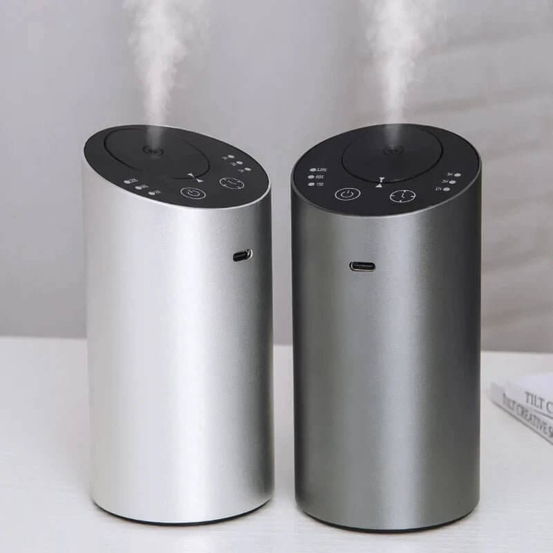 Waterless Car Scent Diffuser Nebulizer, Smart Sleep Device in silver and black with mist.